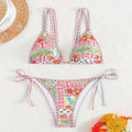 Women's lace-up split swimsuit in picture colour, showing backless brief design for swimming.