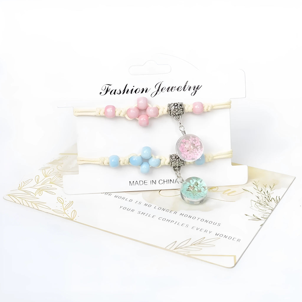 Close-up of a women's glass bracelet with real dried flowers inside, showing large 1.4 cm beads in a blue colour.