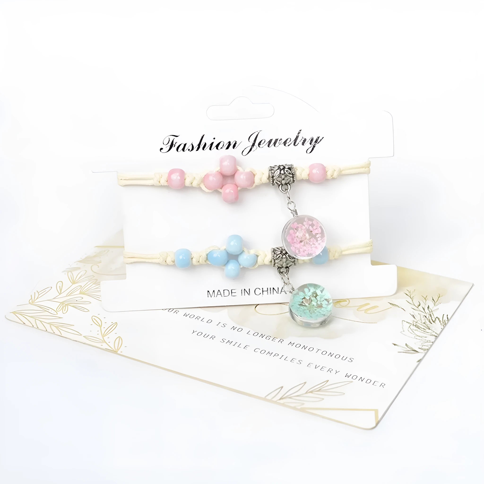 Close-up of a women's glass bracelet with real dried flowers inside, showing large 1.4 cm beads in a blue colour.