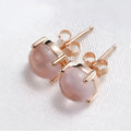 Rose gold coloured drop shaped stud earrings for women with a synthetic quartz stone.