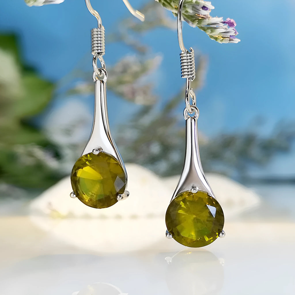 Olive green drop-shaped alloy earrings with posts on a white background.
