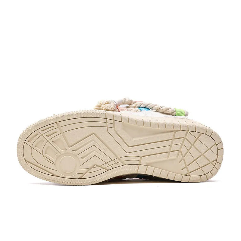 Cream coloured retro lace-up low-top skate shoes on a white background.