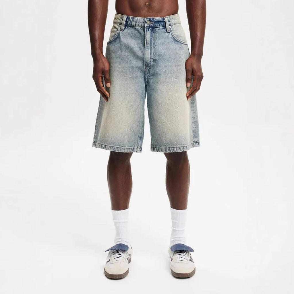 Men's light blue loose fit straight-leg denim jeans on white background