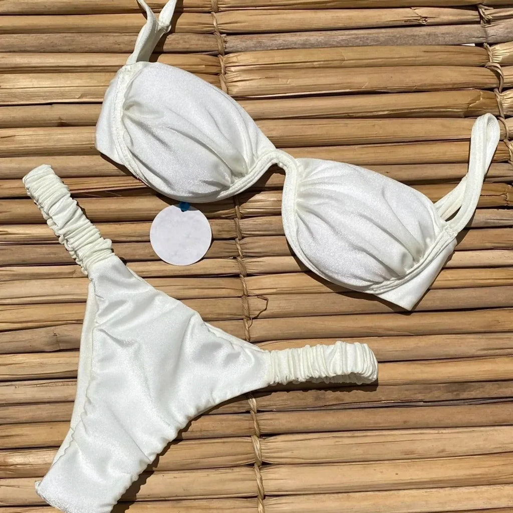 Women's black underwire bikini swimsuit with split briefs, shown on a model.