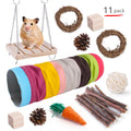 Assortment of natural wooden chew toys for small pets including balls and woven items on a straw mattress.