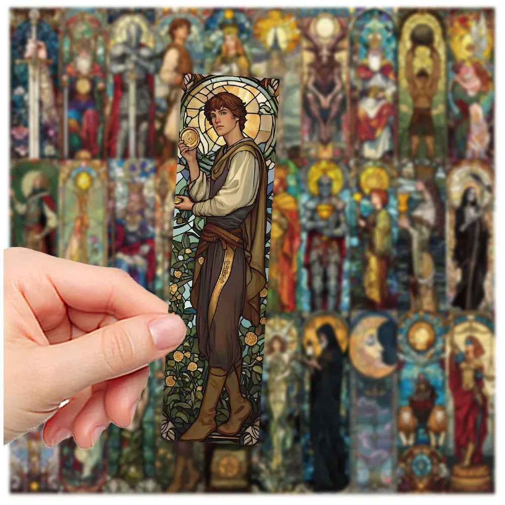 Set of 30 painted glass tarot bookmarks with cute artwork on paper, laid out flat.