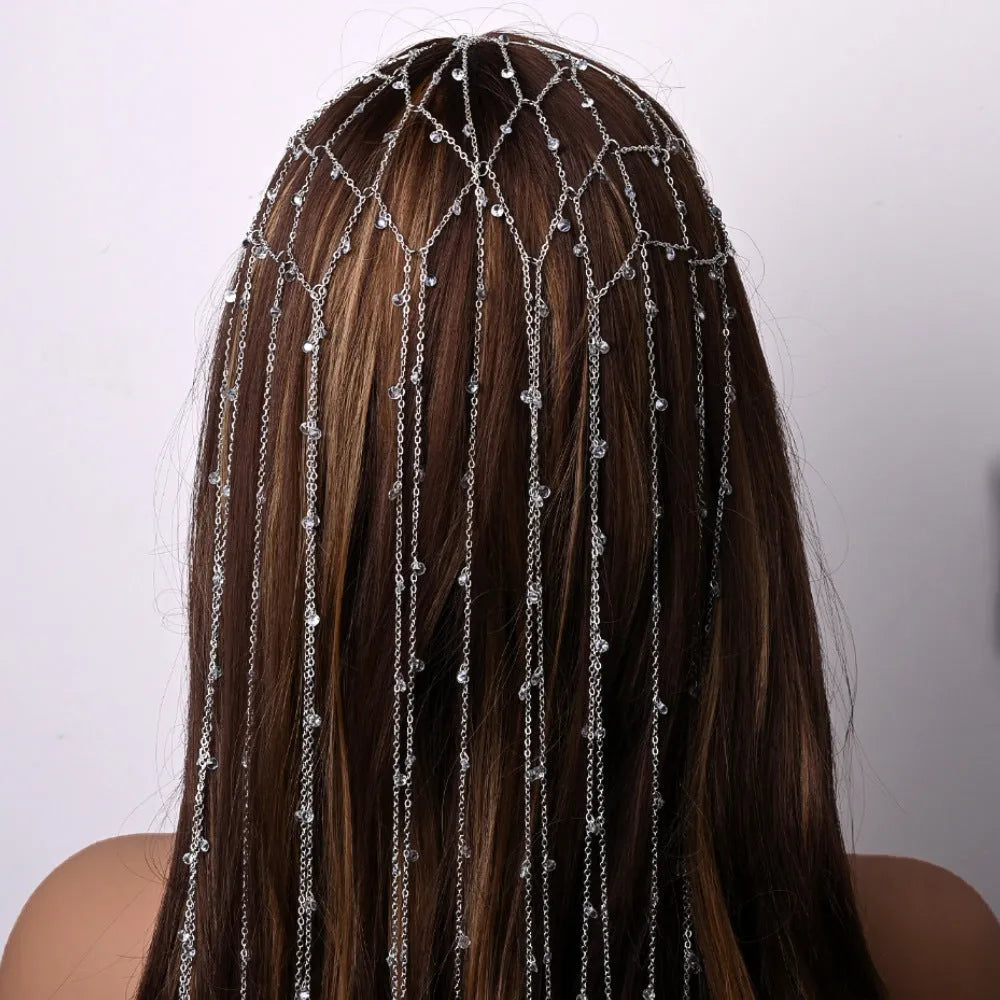 Gold metallic mesh hair band with rhinestone decorations on white background