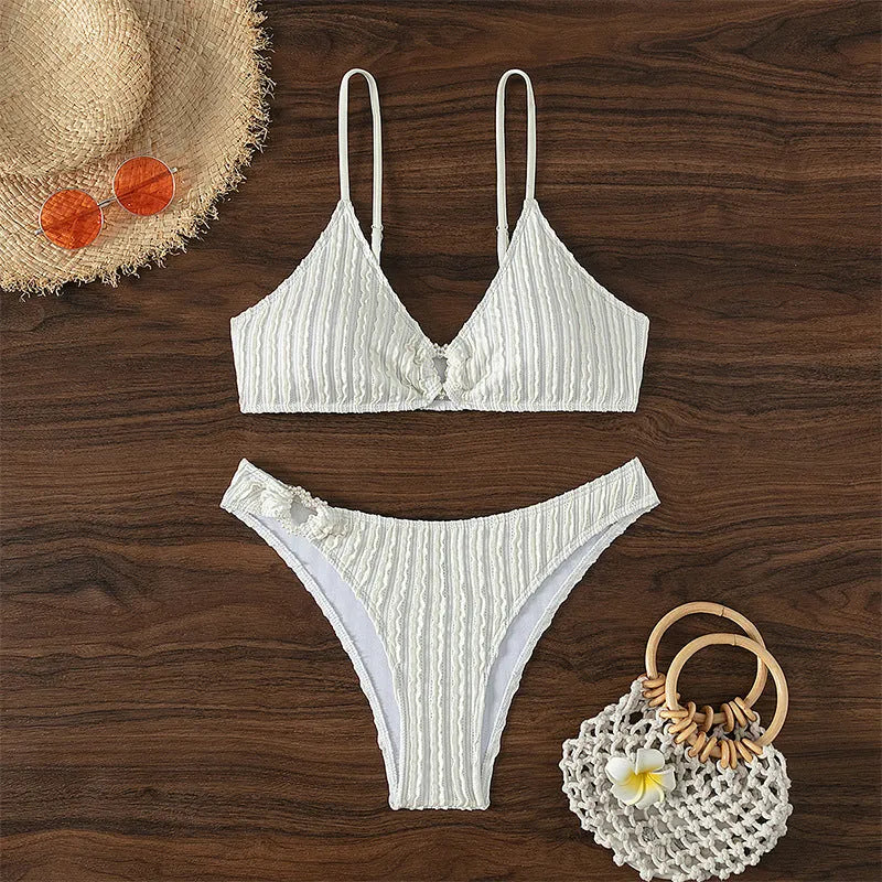 White women's V-neck bikini set with sleeveless top and shorts on a plain background.