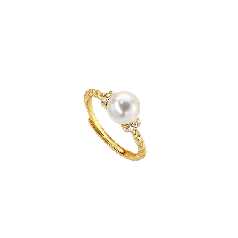 Adjustable copper ring with geometric twist design and pearl inlay in gold colour