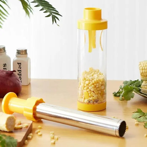 Yellow manual corn stripper with cylindrical ABS plastic body and stainless steel insert on white background