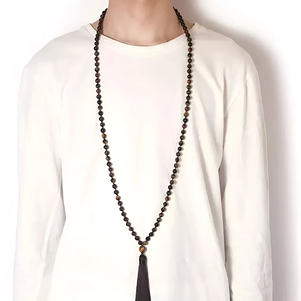 Long beaded agate and amethyst tassel necklace with blue grain stone and lapis lazuli on a geometric design.