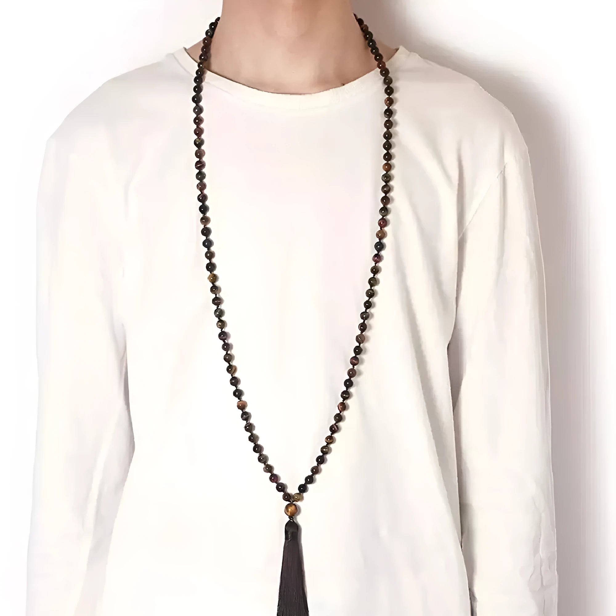 Long beaded agate and amethyst tassel necklace with blue grain stone and lapis lazuli on a geometric design.
