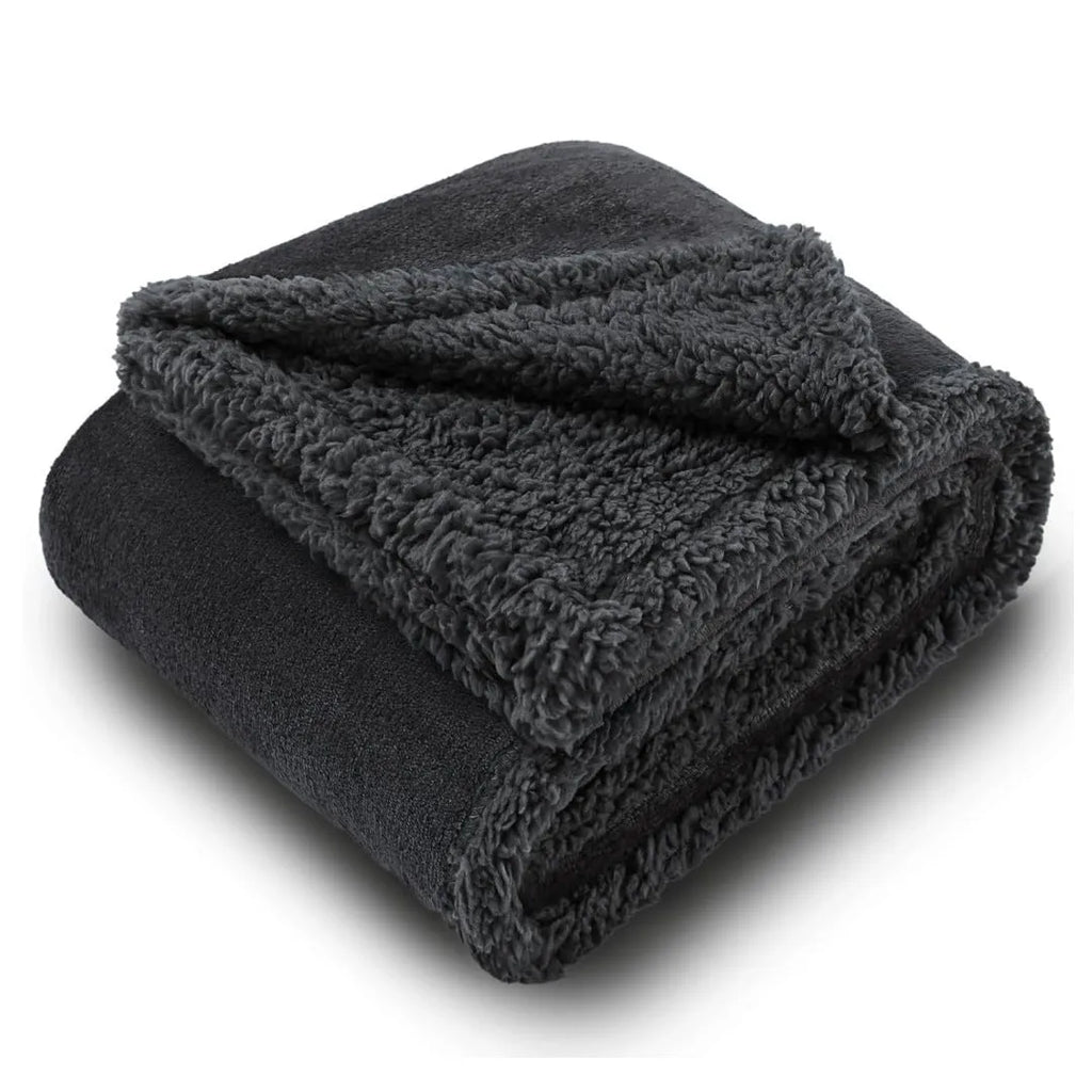 Pet waterproof blanket in beige flannel on a sofa with a dog lying on it
