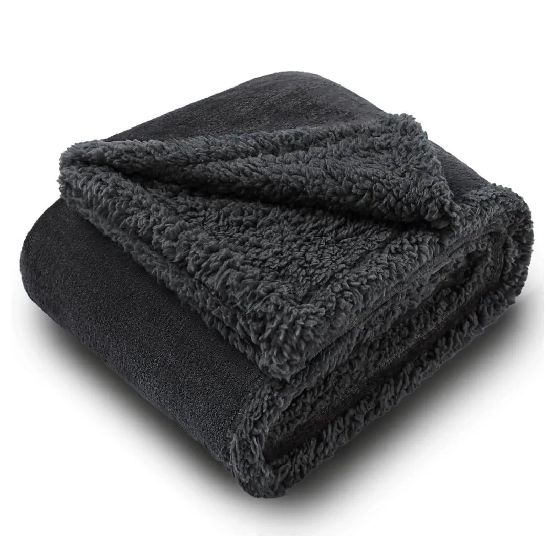 Pet waterproof blanket in beige flannel on a sofa with a dog lying on it