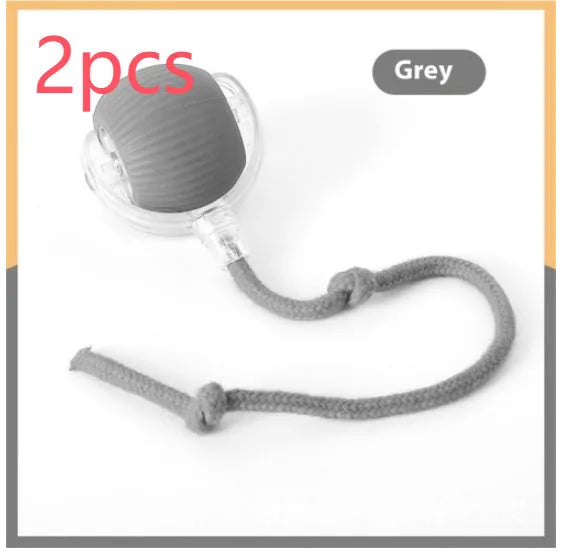 Electric cat toy automatic rolling ball in blue with rope attachment, on wooden floor