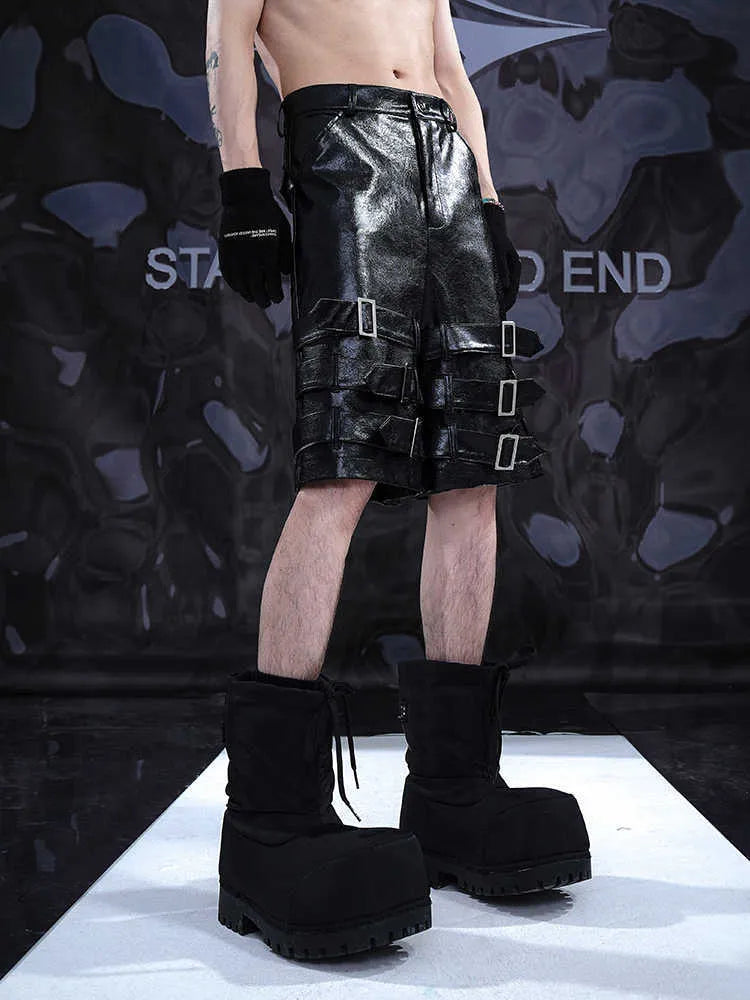 Men's black PU leather cropped shorts with leather ring details on a mannequin.