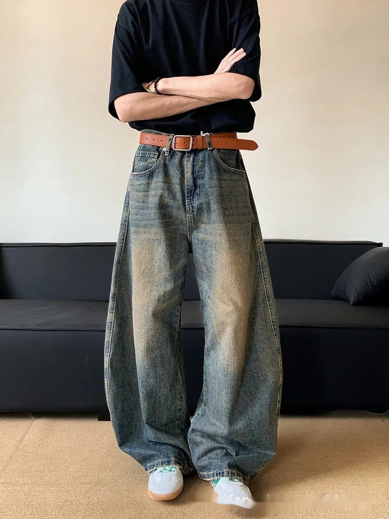 Men's retro blue distressed wide-leg jeans with a slimming fit through hips and thighs.