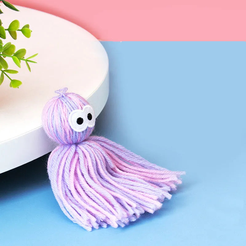 Wool ball cat toy with hanging loop in blue-grey colour combination