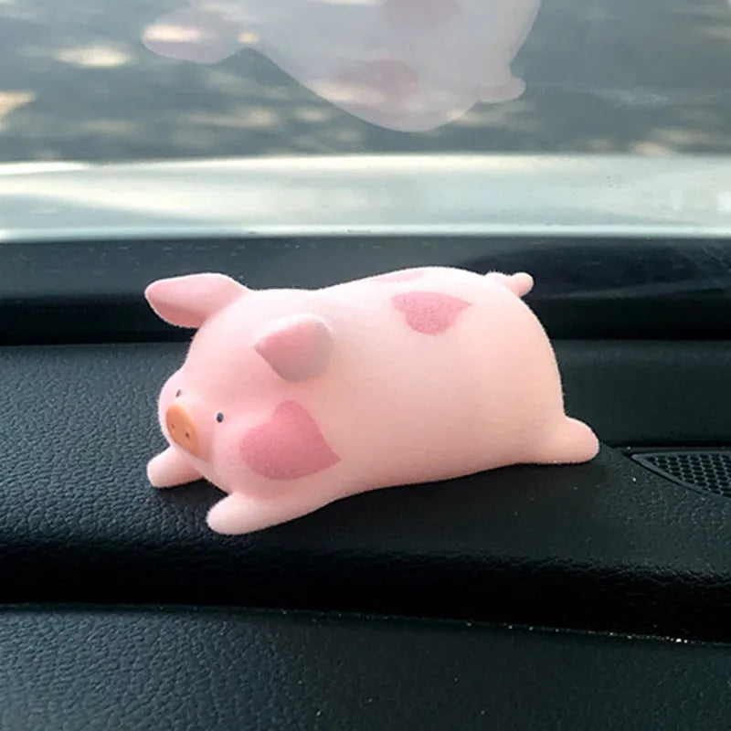 A cartoon pig figurine car dashboard ornament made of resin.