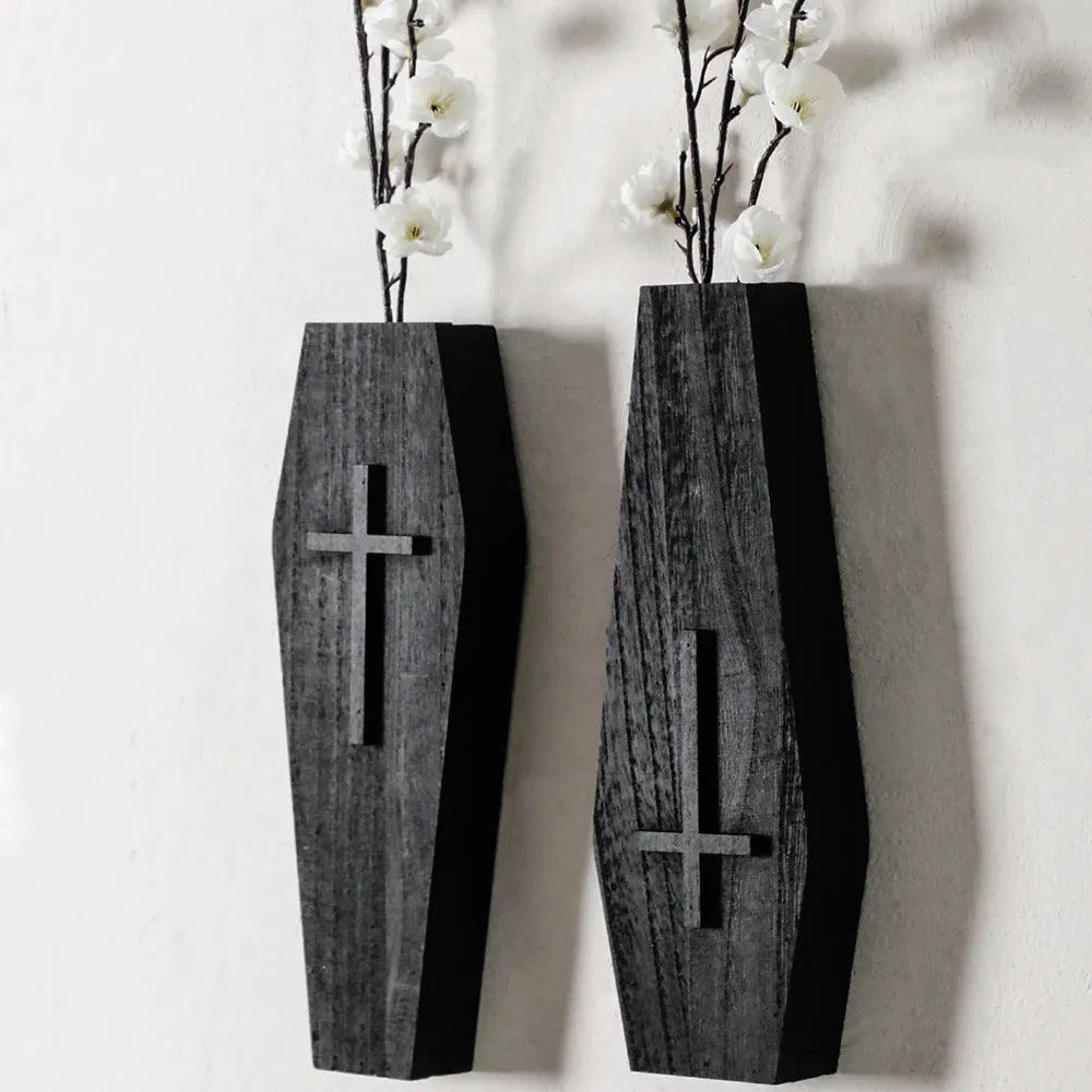 Black cross-shaped wooden wall vase shelf with a compact 27 cm ledge for holding a small vase or ornament