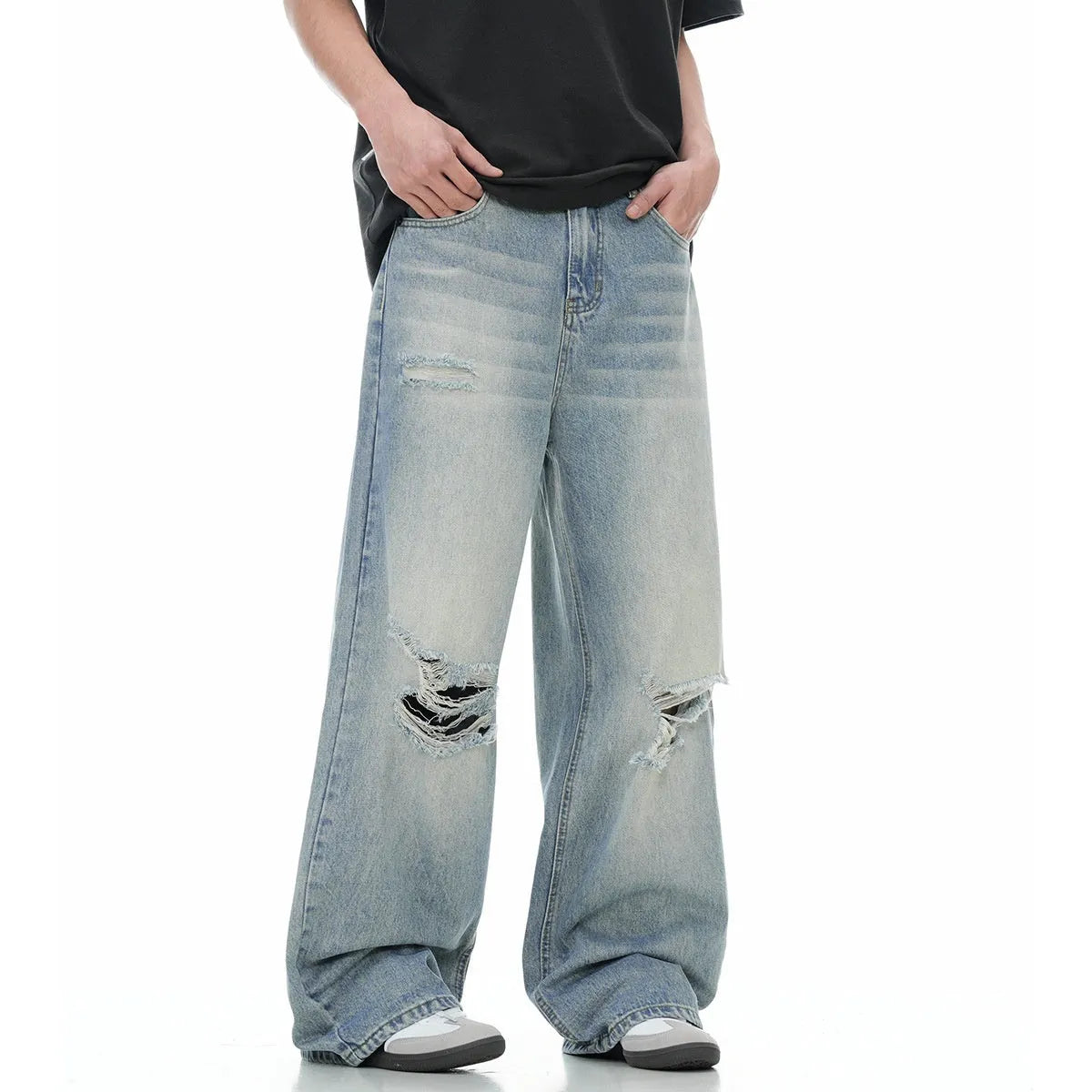 Blue men's straight-leg jeans with vintage rip detailing and zipper fly closure