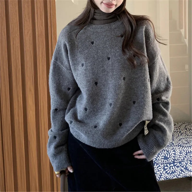 Women's loose grey acrylic pullover sweater with love pattern embroidery on the front.