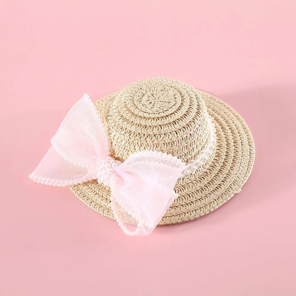 Pet cat wearing woven straw hat with pearl bow decoration in seasonal colour option