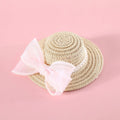 Pet cat wearing woven straw hat with pearl bow decoration in seasonal colour option