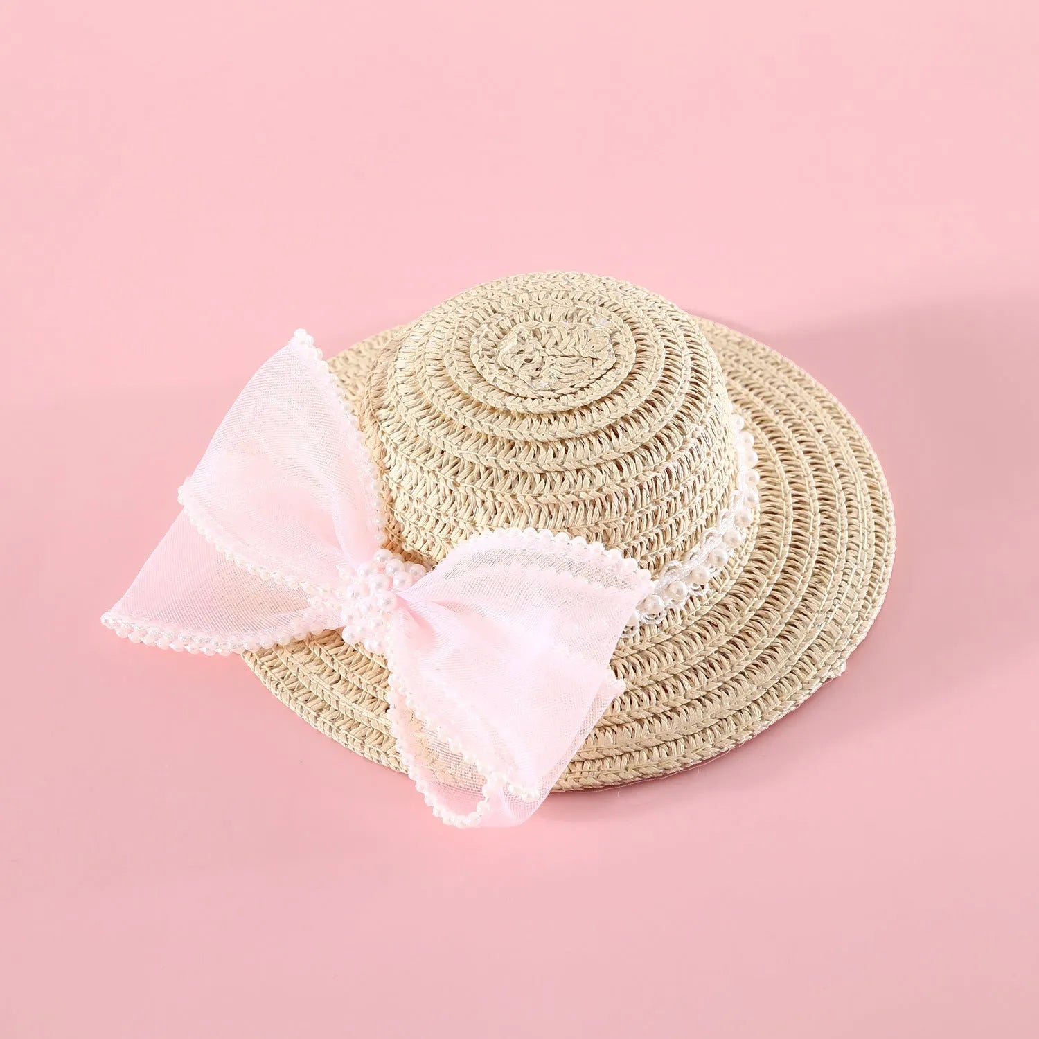 Pet cat wearing woven straw hat with pearl bow decoration in seasonal colour option