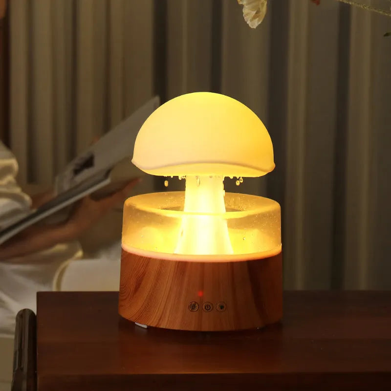 White cloud-shaped humidifier with falling water droplets and coloured night light