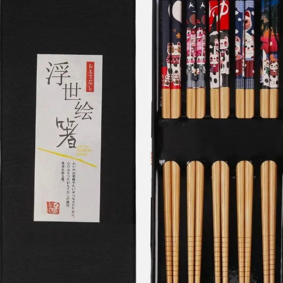 Set of five pairs of bamboo chopsticks with colourful lucky cat cartoon pattern.