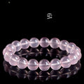 Women's natural starlight crystal round bead bracelet in pink on a white background.