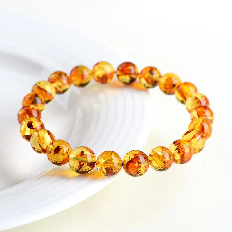 Natural yellow piebald amber bracelet with geometric beads showing distinctive flower spot patterning