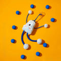 Blue plush cat toy with telescopic elastic rope, ring with bell and mint element on white background