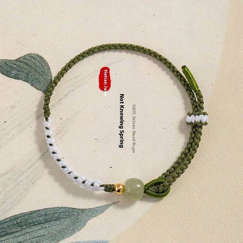 Colourful national fashion bracelet with Hetian jade and sterling silver carrying strap on a neutral background