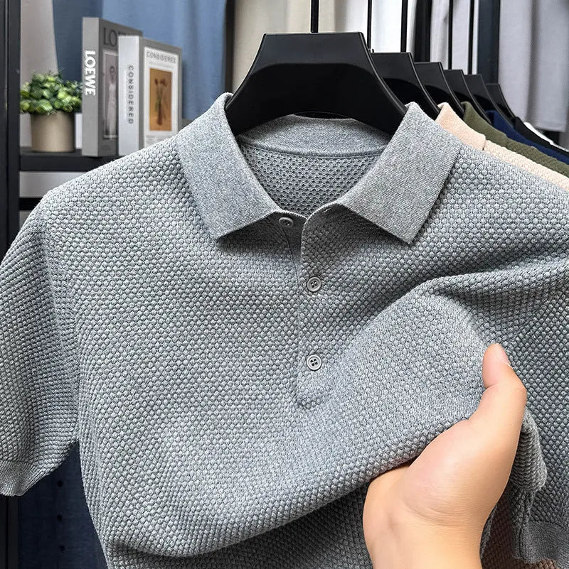 Man wearing a loose grey short sleeve cotton sweater, casual pullover style