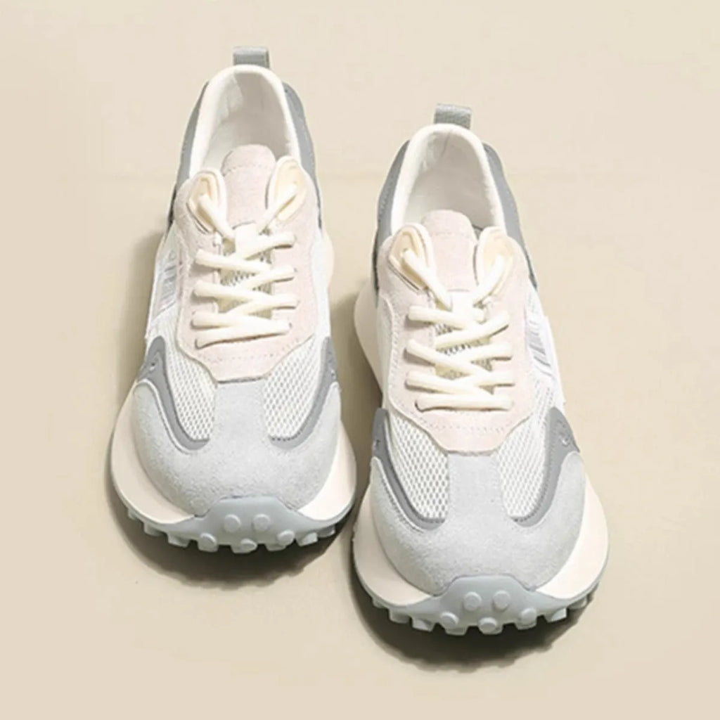 Women's grey retro low-top sneaker with round toe and flat rubber sole on a neutral background.