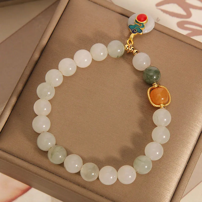 Women's ice jade crystal bracelet with pearl accents and retro design on display