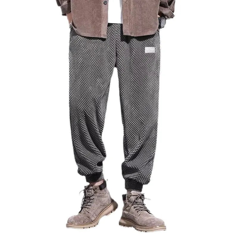 Men's grey straight-leg sweatpants with ankle ties laid flat.