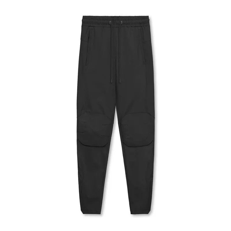 Men's grey quick-dry fitness pants with ankle ties shown in loose fit for exercise