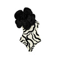 One-piece European American style swimsuit with three-dimensional floral patterns on solid colour background