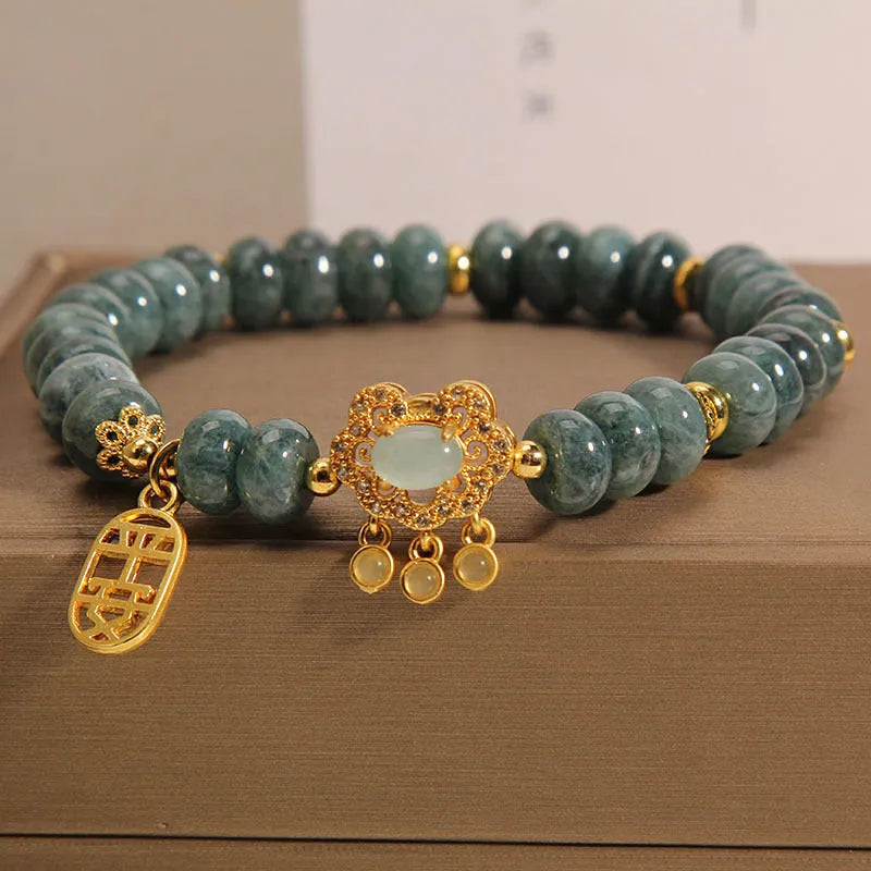 Natural emerald jade bracelet for women with abacus beads and a safety lock clasp on a white background.