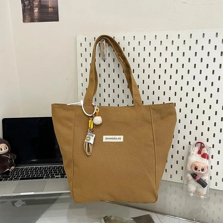 Canvas casual large capacity shoulder bag for women in four colours with pendant options