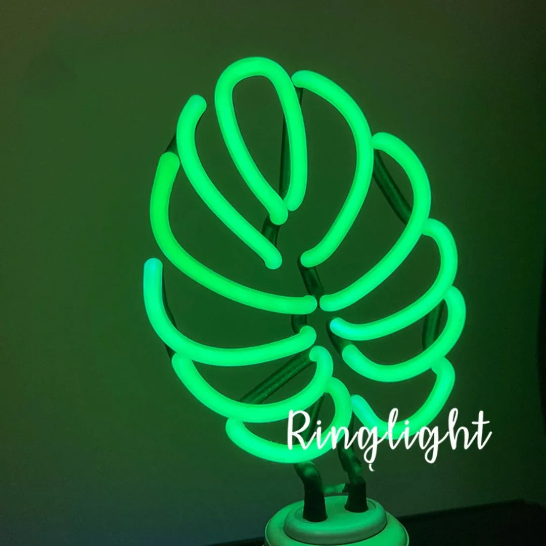 Minimalist bamboo-shaped desktop lamp with green light in white tube, showing large and small size options