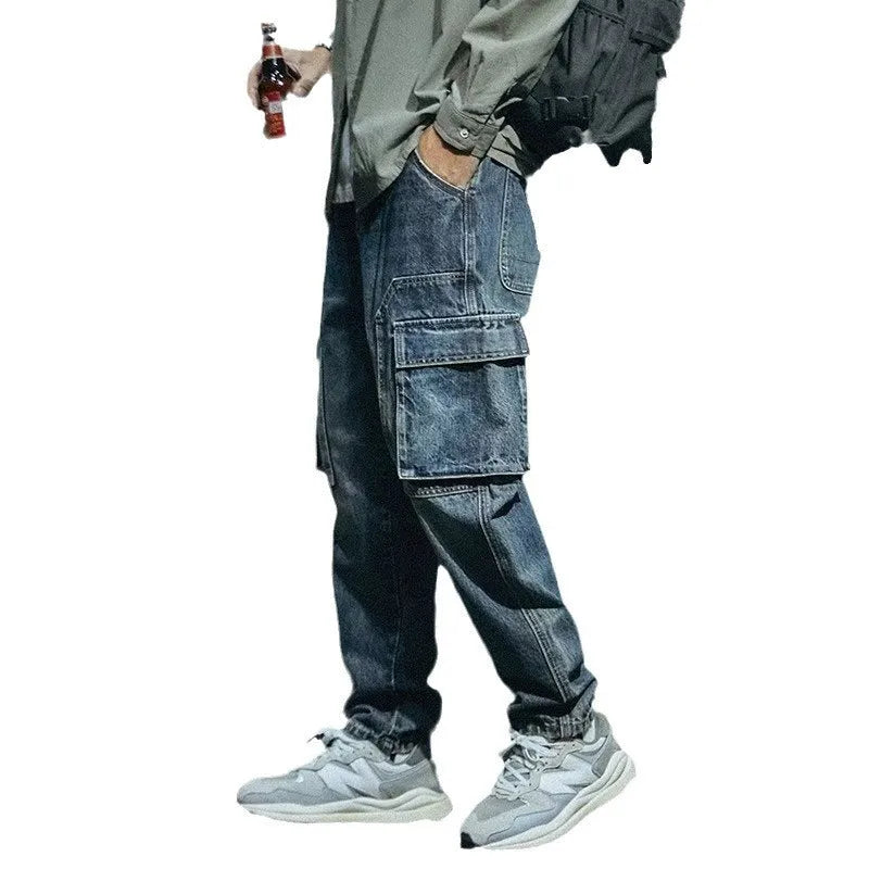Man wearing blue loose straight-leg retro style stretch denim casual trousers
