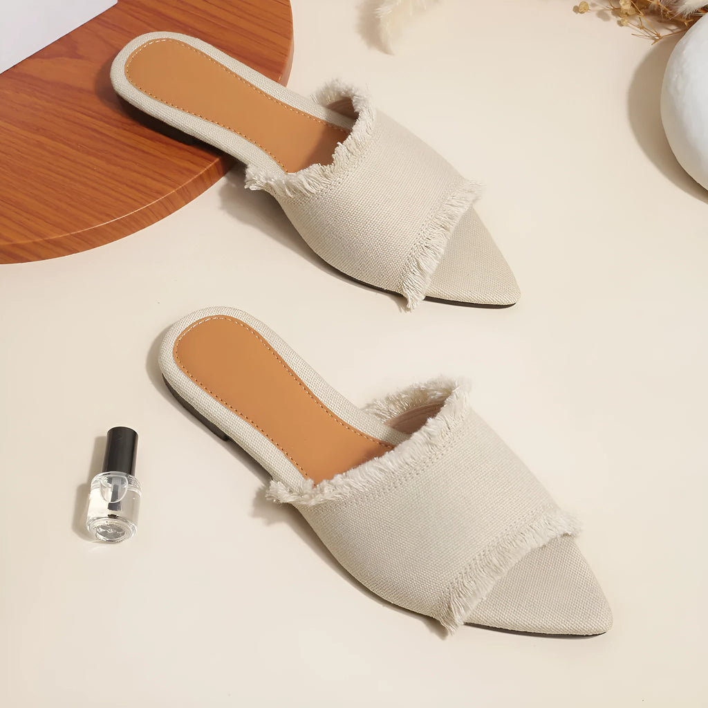 Women's casual denim flat slippers with a tassel detail and leather lining, shown in apricot colour.
