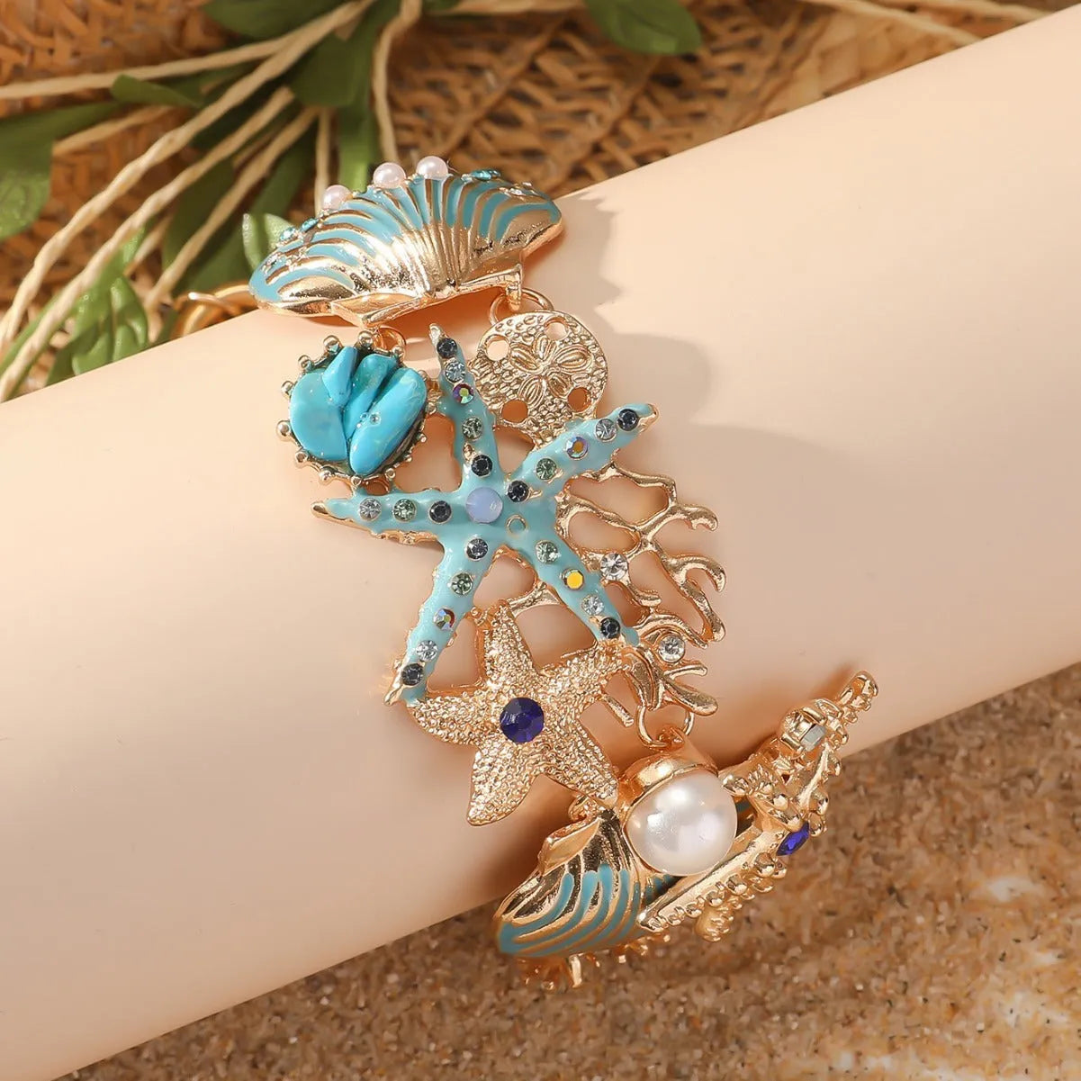 Women's alloy bracelet with rhinestone boat anchor charm and starfish detail in turquoise, red, or blue.