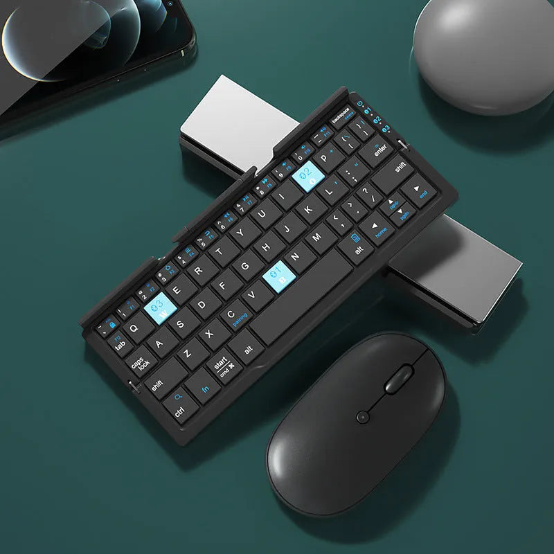 Silver folding Bluetooth keyboard propping up smartphone with hidden stand extended