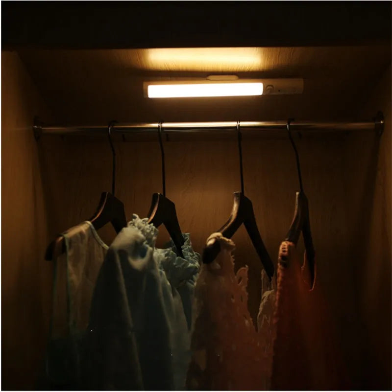 Battery-powered infrared sensor LED wall light with magnetic mount for cabinets.