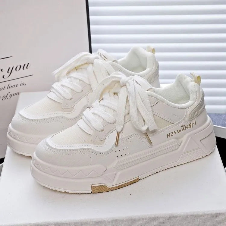 Children's beige height increasing trainers with thick rubber sole, lace-up front, and cross shoulder straps.